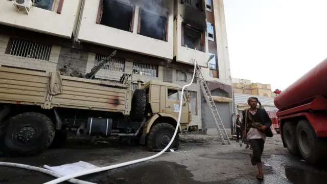 Houthi fighters stand outside Ali Abdullah Saleh's home in central Sanaa on 4 December 2017