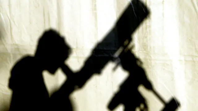 Sombra de un joven viendo telescopio