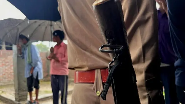 Police at the home of victims in Lakhimpur