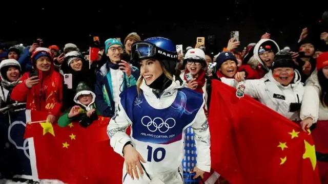 谷爱凌和手持中国国旗的粉丝站在一起