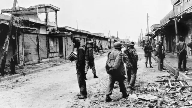 이란 군인들이 1980년 전쟁으로 파괴된 도시를 순찰하고 있다