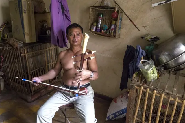 Resident playing on a traditional instrument