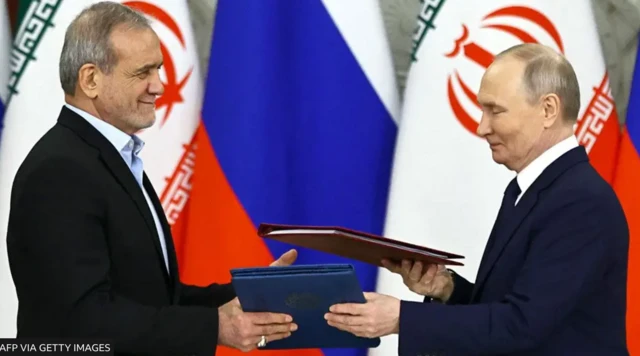 Russian President Vladimir Putin and Iranian President Masoud Pezeshkian sign a strategic partnership treaty during a ceremony following their talks at the Kremlin in Moscow on January 17, 2025. 