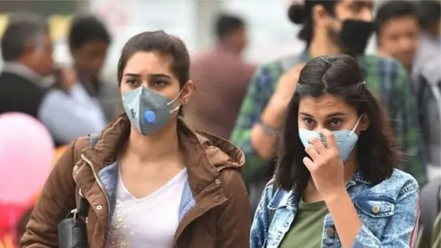 మాస్కులతో వెళ్తున్న ప్రజలు