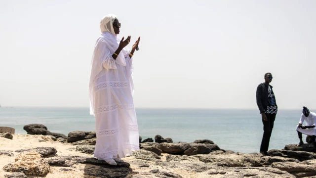 A woman prayer above a cave in Ngor, Dakar in Senegal - Friday 4 March 2022