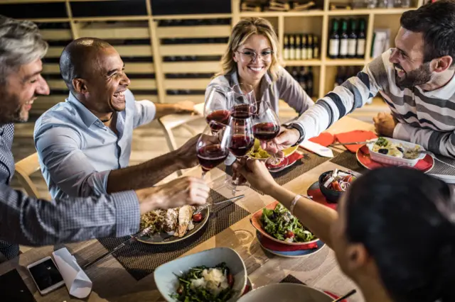 A group sharing food and wine