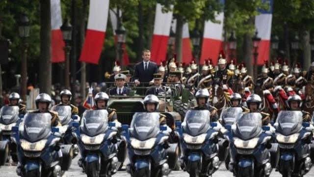 The new French president was driven in an open-top military vehicle up the Champs-Élysées