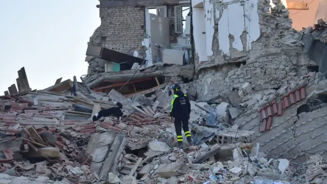 Un rescatista busca a sobrevivientes en Pescara del Tronto.