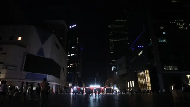 People walk in darkness in Chengdu, Sichuan