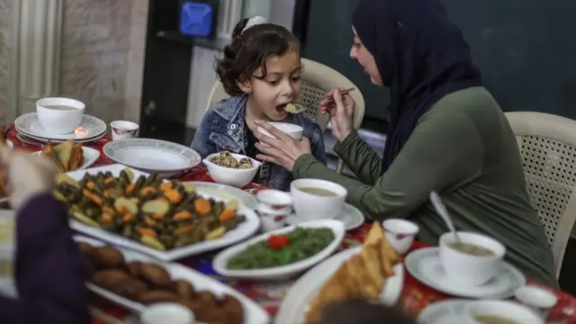 Degma family, who lived in the town of Abasan el-Cedide in Khan Yunis is having Iftar in their home as a precaution against coronavirus (Covid-19) in Gaza on April 24, 2020.