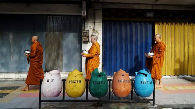 Buddhist monks in Indonesia collect alms one day before Vesak day in Magelang on May 28, 2018.