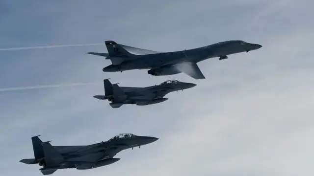 A U.S. Air Force B-1B Lancer bomber (Top) fly with South Korean jets over the Korean Peninsula during a South Korea-U.S. joint live fire drill on July 8, 2017 in Korean Peninsula, South Korea