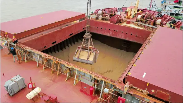 A crane unloads soybeans imported from Brazil at Nantong Port on August 21, 2018 in Nantong, Jiangsu Province of China