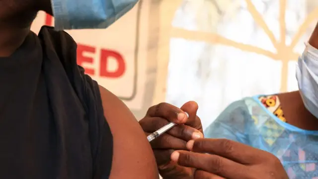 Une infirmière administre un vaccin Covid-19 à une personne au centre de vaccination du Palais des Sports à Yaoundé, le 6 janvier 2022.