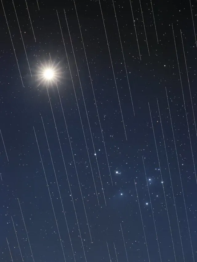 Starlink satellites cross over Venus and the Pleiades ("Seven Sisters") group of stars