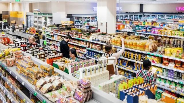 Personas comprando en un supermecado bien surtido