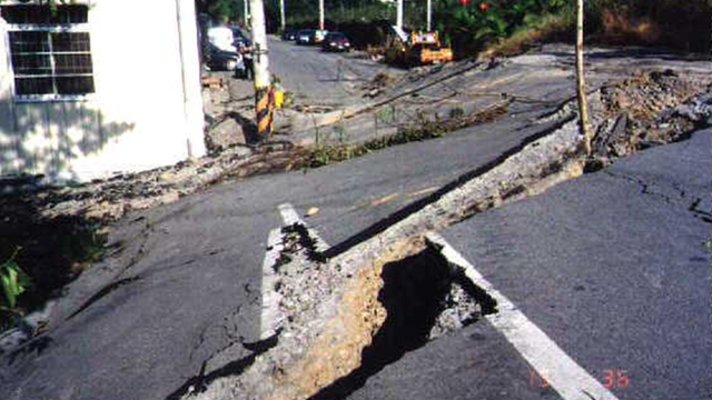 當年地震過後隆起的路面，斷層旁的住宅街被毀損。