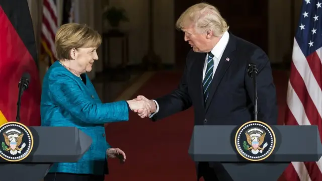 U.S. President Donald Trump (L) and German Chancellor Angela Merkel (R) shake their hands after the joint press conference at the White House during Chancellor Merkel's visit to Washington, United States on March 17, 2017.