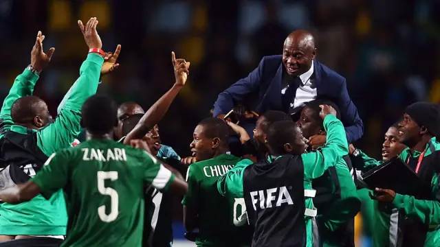 Nigeria players and team members carry head coach Emmanuel Amuneke after winning the U-17 World Cup