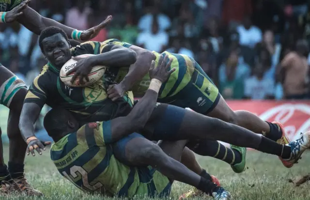 Kabras Sugar's Johnston Mungau (C) is tuckled by Kenya Commercial Bank's Brian Omondi (L) and Peter Kilonzo during the Kenya Cup's final match between Kenya Commercial Bank and Kabras Sugar at the KCB Sports Club in Nairobi, on March 24, 2018