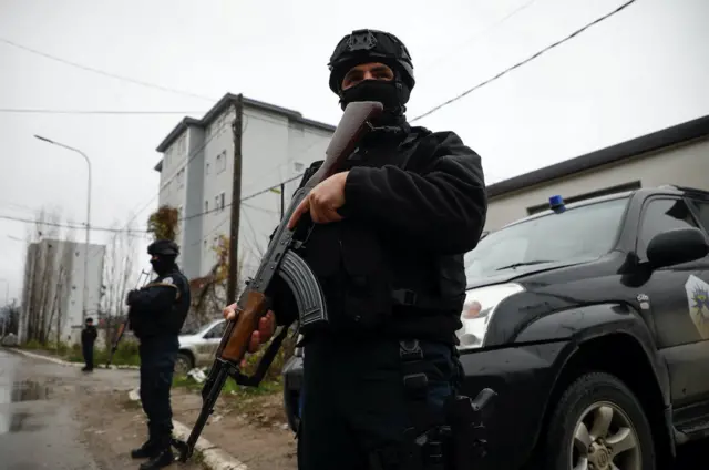Kosovo police officers patrol an area in the northern part of the ethnically-divided town of Mitrovica, Kosovo, December 12, 2022.