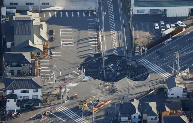 An aerial view shows a large sinkhole that formed when a sinkhole that swallowed a truck and a man believed to be its driver at an intersection in Yashio, formed on January 28, 2025, and another that formed during rescue operations, merged, near Tokyo, Japan January 30, 2025, in this photo taken by Kyodo. Kyodo/via REUTERS ATTENTION EDITORS - THIS IMAGE HAS BEEN SUPPLIED BY A THIRD PARTY. MANDATORY CREDIT. JAPAN OUT. NO COMMERCIAL OR EDITORIAL SALES IN JAPAN.
