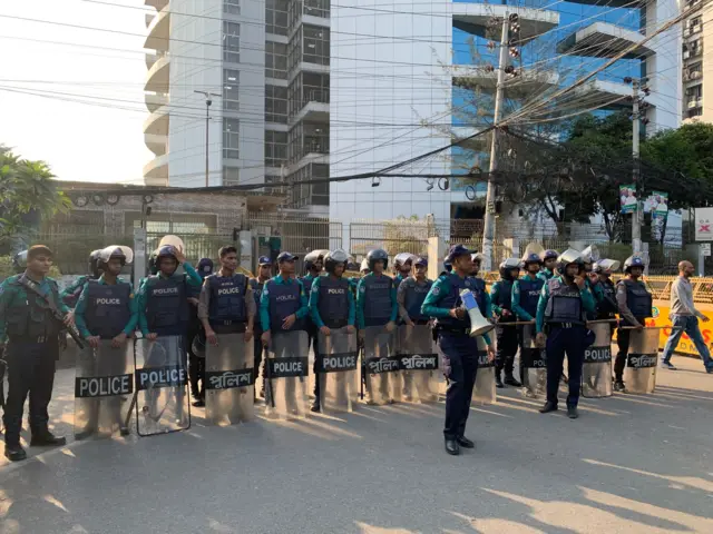 নির্বাচন কমিশনের বাইরে সারিবদ্ধভাবে দাঁড়িয়ে আছেন পুলিশের কিছু সদস্য