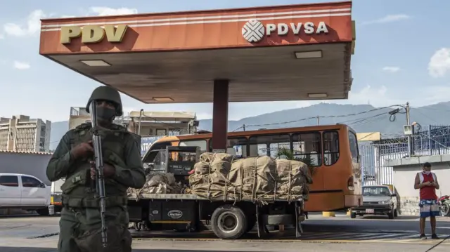 Militar armado vigiando um posto de gasolina em Caracas em 2020.