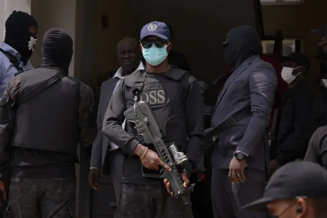 Armed DSS operatives cover dia faces mount for court