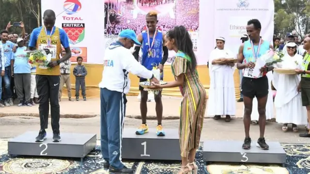 ናሆም ኤርምያስ ኣብ 2023 ተዓዋቲ ማራቶን ኣስመራ ምስ ኰነ ካብ ሃላፊ ባህልን ስፖርትን ኤርትራ ኣምባሳደር ዘመደ ተኽለ ሽልማት እናተቐበለ