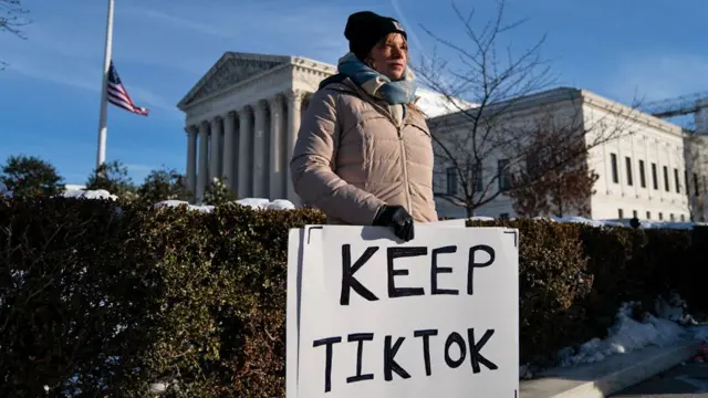 One woman hold one sign wey read 'Keep TikTok' standing in cold-weather clothes outside di Supreme Court for US.