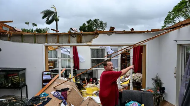 Un hombre señala daños en su casa en Ft Myers