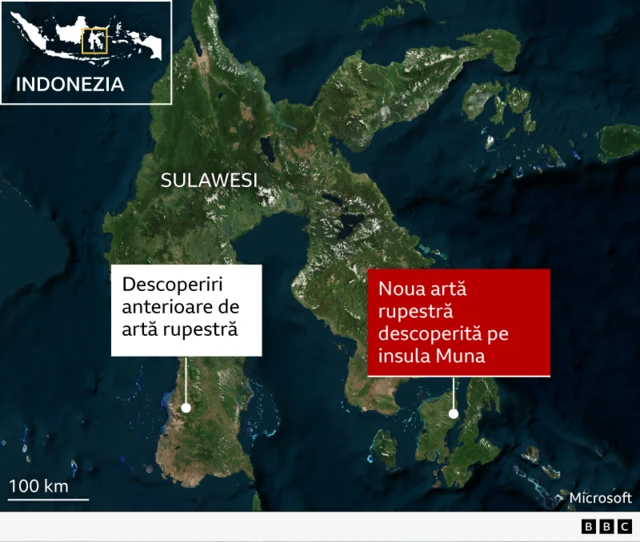 Cele mai vechi descoperiri de artă rupestră din Sulawesi, Indonezia
O hartă de tip imagine din satelit prezintă insula indoneziană Sulawesi și marea înconjurătoare, văzute de sus, cu uscat verde și ocean albastru închis.
În colțul din stânga sus se vede o hartă mică a Indoneziei, cu un dreptunghi galben ce evidențiază locația insulei Sulawesi. Text mare, alb, etichetează insula principală „Sulawesi”.
Aproape de sud‑vestul Sulawesi, un punct alb și o etichetă albă indică „Descoperiri anterioare de artă rupestră”. În sud‑est, pe o masă de uscat mai mică alăturată, un al doilea punct alb este conectat la o etichetă roșie pronunțată care spune „Nouă artă rupestră descoperită pe insula Muna”.
În stânga jos, o scară indică „100 km” deasupra „100 mile”.