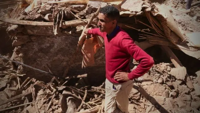 Ed-Abdullah lean on pile of bricks near house wey collapse