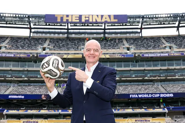 Fifa President Gianni Infantino poses with the TRIONDA FINAL the Official Match Ball for the semi-finals, bronze final and final during his visit to the New York New Jersey Stadium on July 09, 2026 in East Rutherford, New Jersey. 