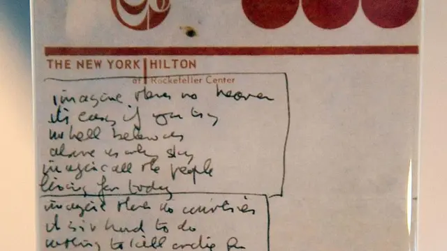 Una servilleta con el logotipo del New York Hilton Hotel en la que puede leerse la letra de la canción escrita con tinta azul.