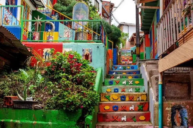 Escada colorida ao lado de um pequeno jardim em Guatapé, na Colômbia