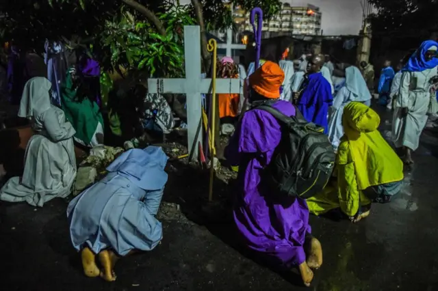 Hundreds of Legio Maria Church members, wearing colourful clothes, gather to march to the church in the town with the Christmas Eve celebrations in the town of Mathare in Nairobi, Kenya on December 24, 2024. 