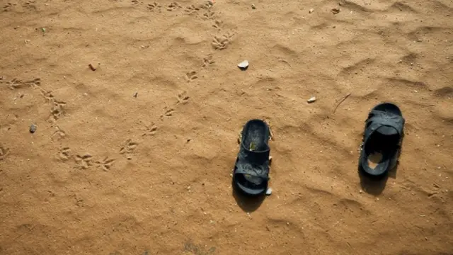አሸዋ ውስጥ የቀረ ነጠላ ጫማ