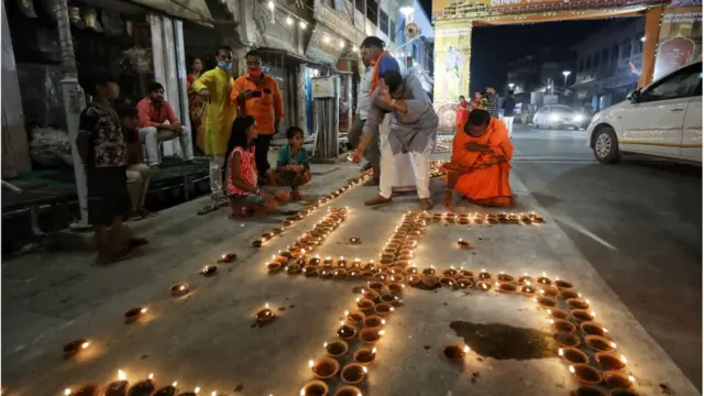 Devotees lighting earthen lamps in Ayodhya