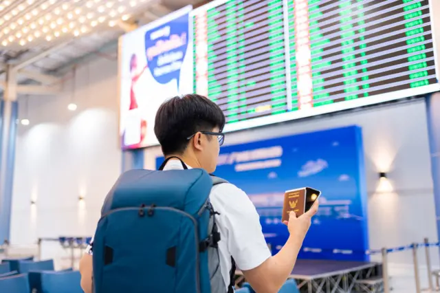 A man hold Thai passport