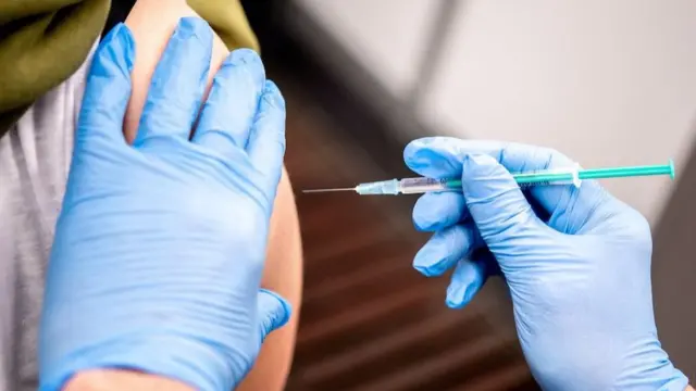 Marie Rohlfs, teacher at the Sternschnuppe Kindergarten receives a dose of AstraZeneca"s vaccine against the coronavirus disease (COVID-19) from Thomas Holler in Bremen, Germany, February 26, 2021.