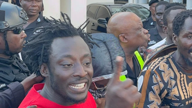 Photo of one of di lead conveners Ralph St. Williams being escorted into a waiting police van