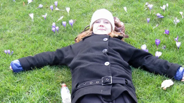 Sue lying in the grass