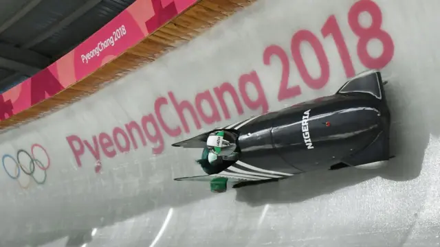 Team leader and driver Seun Adigun of Nigeria take a turn during the first unofficial bobsleigh women training session at the Olympic