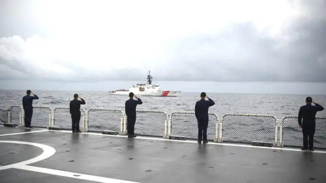 Philippine coast guard personnel aboard Gabriela Silang salute during a passing honour ceremony at the conclusion of a joint search and rescue exercise between the Philippine and US coast guards in the vicinity of the South China sea off Zambales on September 3, 2022. (