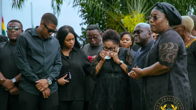ghana's first lady Lordina mahama and her children, flanked by the chief of staff as they paid floral tribute to the victims. The first lady is in tears and had to be consoled by the chief of staff