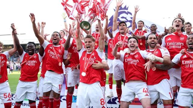 The Arsenal squad celebrate with the Premier League trophy