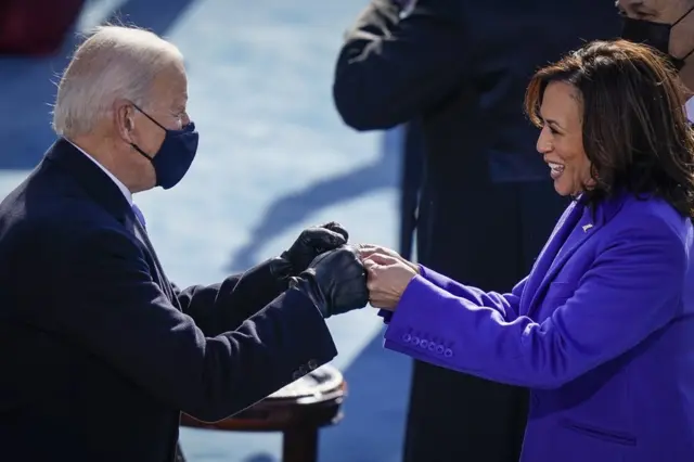US President Joe Biden fist bumps Vice President Kamala Harris during their inauguration on the West Front of the US Capitol on 20 January in Washington, DC