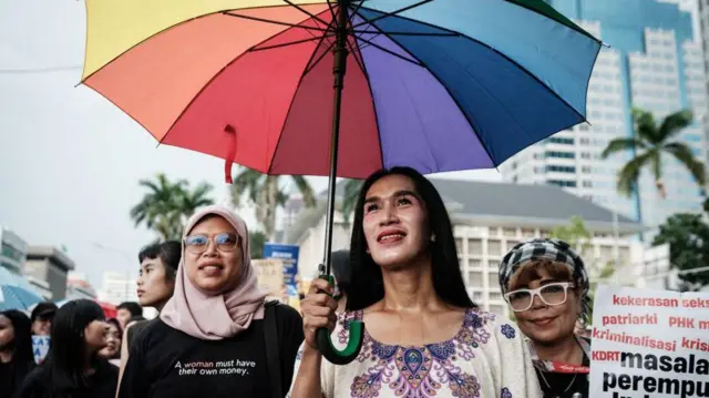 Echa Wa'ode (C), seorang aktivis dari Arus Pelangi, sebuah organisasi hak LGBTQ+ Indonesia, berbaris bersama dengan peserta lainnya selama protes yang diselenggarakan oleh Aliansi Perempuan Indonesia (API) pada Hari Perempuan Internasional ke-50 yang menuntut hak-hak buruh, kesetaraan gender dan perlindungan, di Jakarta pada 8 Maret 2025.